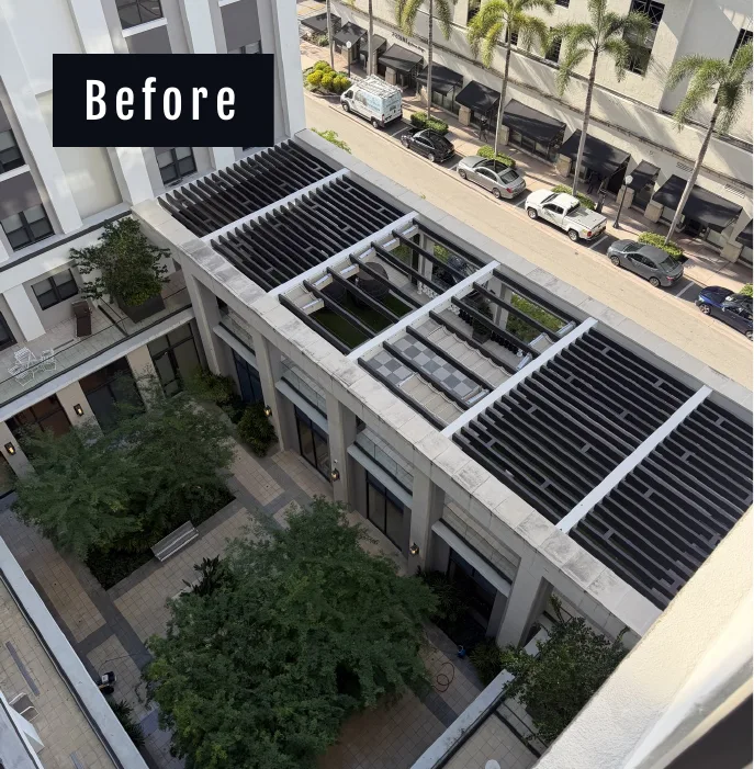 Drone's-eye aerial of the Belmont Village courtyard and pergola before cleaning